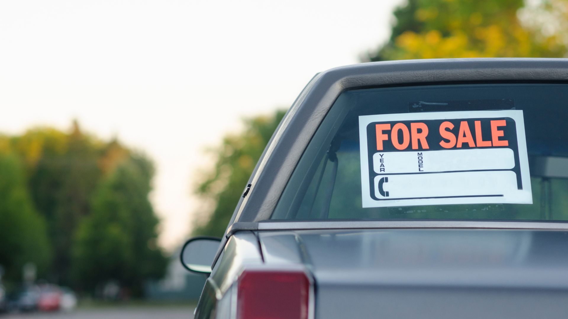 A for sale sign on the back of a car